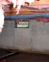 Wisconsin and Illinois crawl space with vents, showing mold, rot, and fiberglass insulation dripping off the ceiling.