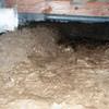 A muddy, disgusting crawl space with little or no head room in Oak Creek.